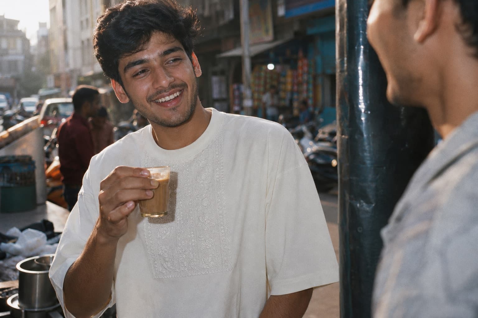 Man in an oversized heavyweight cotton tee with a hand-embroidered chikan chest panel on a Lucknow street